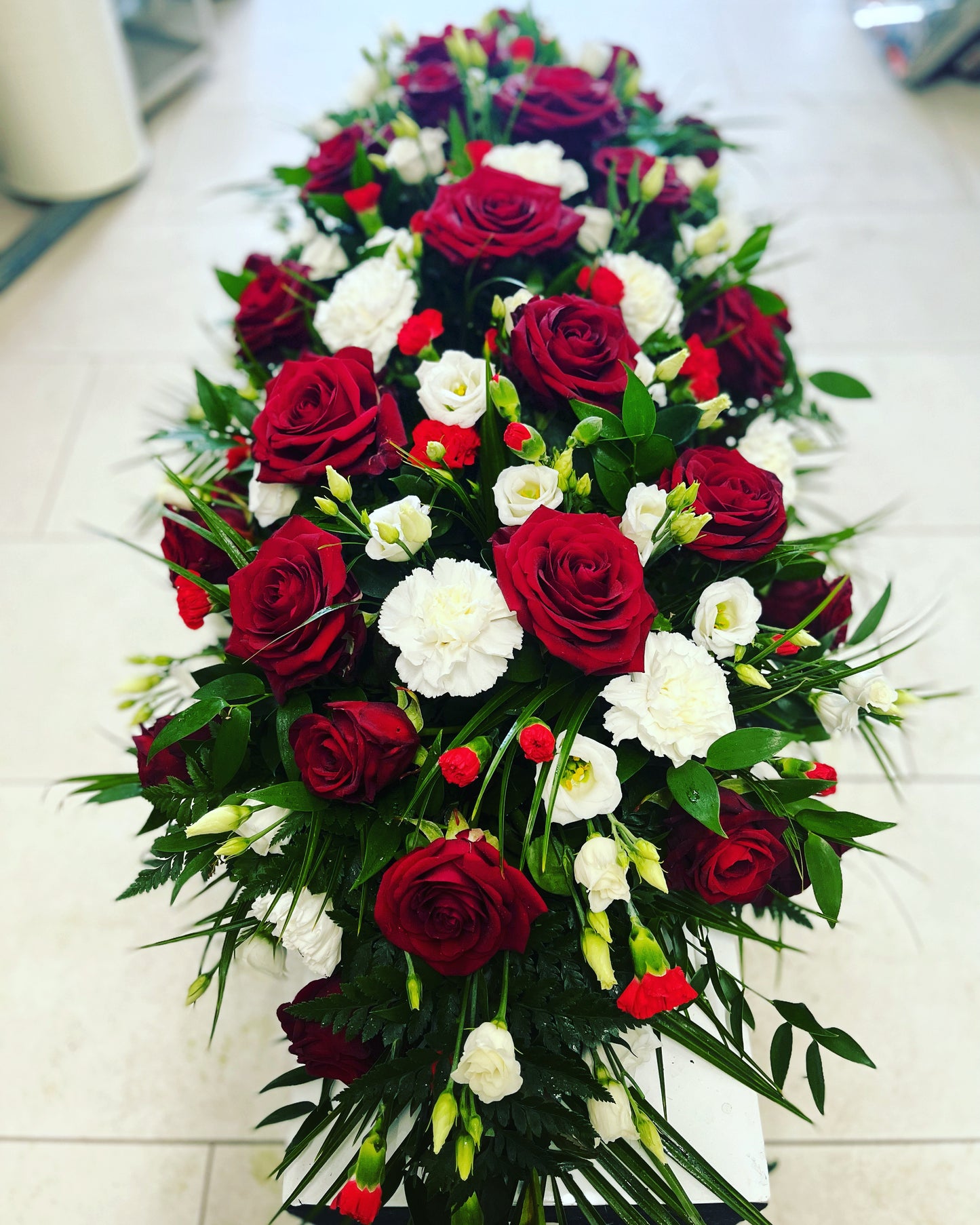 Funeral casket spray Rose and carnations